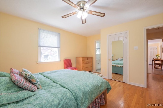 bedroom with light wood finished floors, ceiling fan, and baseboards