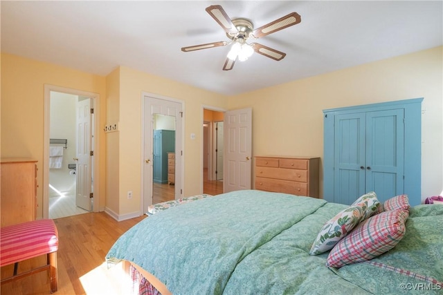 bedroom featuring ceiling fan, baseboards, and light wood-style floors