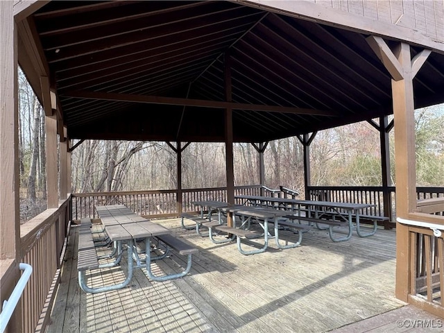 wooden deck with a gazebo and outdoor dining area