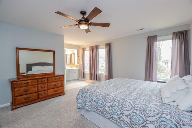 bedroom with multiple windows, carpet flooring, a ceiling fan, and visible vents