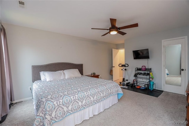 carpeted bedroom with visible vents and a ceiling fan