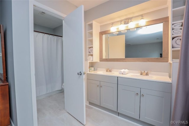 full bathroom featuring double vanity and a sink