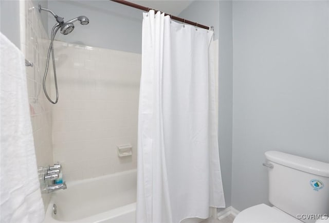 bathroom with toilet and shower / bath combo with shower curtain