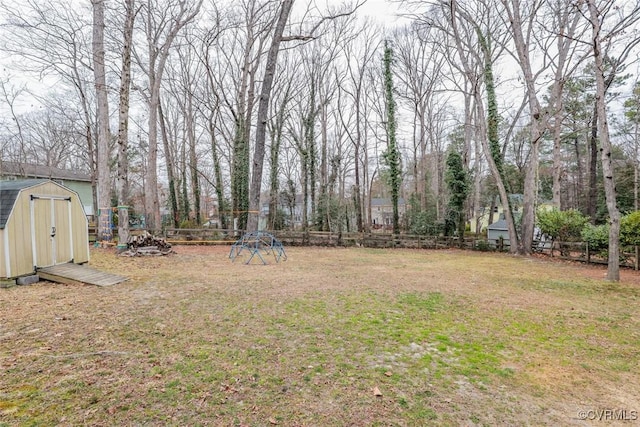 view of yard with an outbuilding, a shed, and a fenced backyard