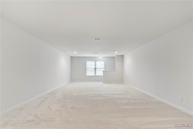 spare room featuring recessed lighting, visible vents, baseboards, and light carpet