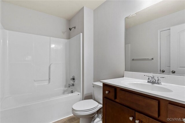 bathroom with tile patterned flooring, tub / shower combination, toilet, and vanity