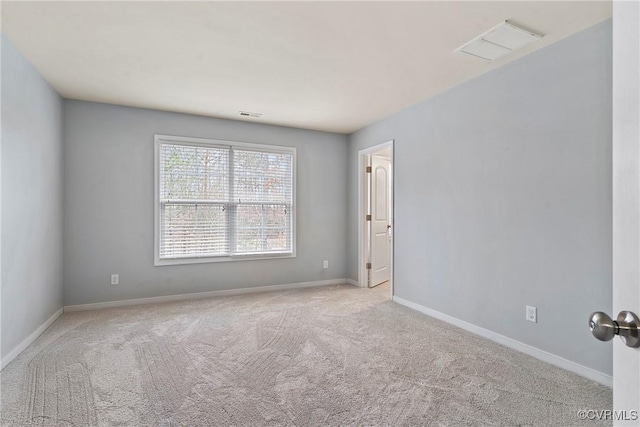 carpeted empty room with baseboards and visible vents