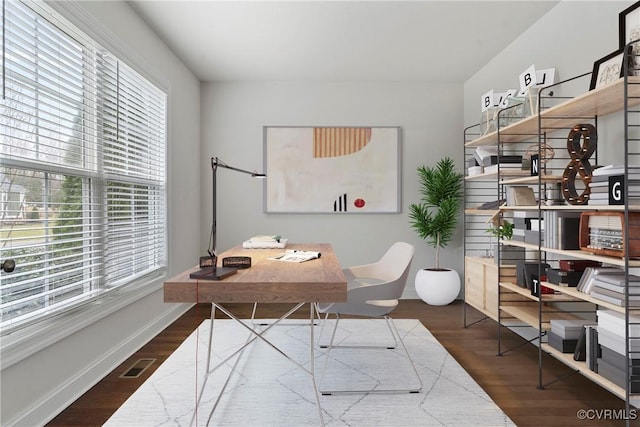 home office with visible vents, baseboards, and wood finished floors