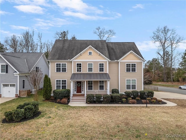 view of front facade featuring metal roof, a porch, concrete driveway, and a front yard