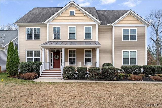 traditional home featuring roof with shingles, a standing seam roof, a porch, a front lawn, and metal roof