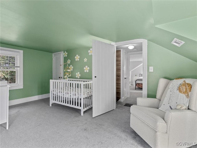 carpeted bedroom with visible vents, baseboards, and vaulted ceiling