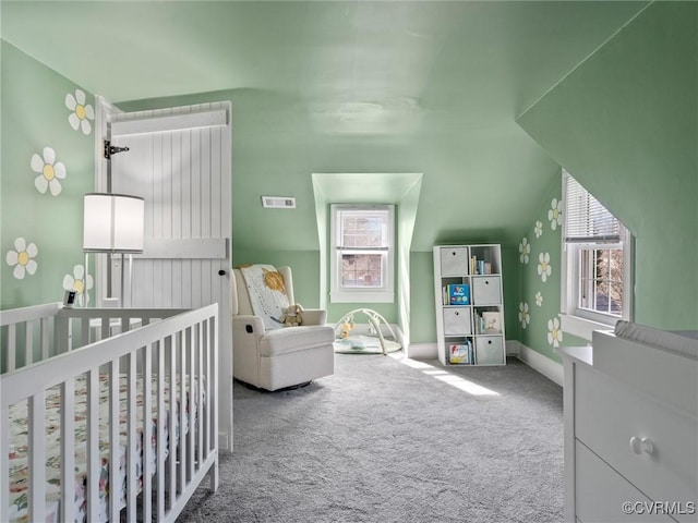 carpeted bedroom with visible vents, multiple windows, and a nursery area