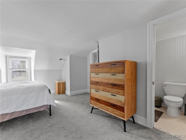 bedroom with vaulted ceiling, carpet flooring, baseboards, and visible vents