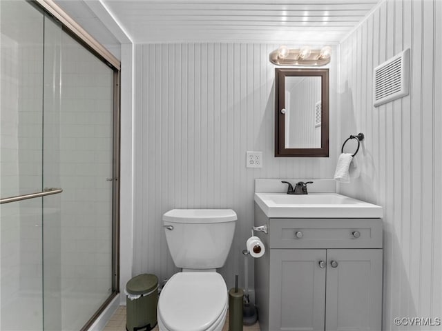 full bathroom featuring vanity, toilet, and a stall shower