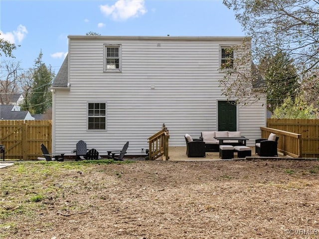 rear view of property featuring a patio, fence, and an outdoor hangout area