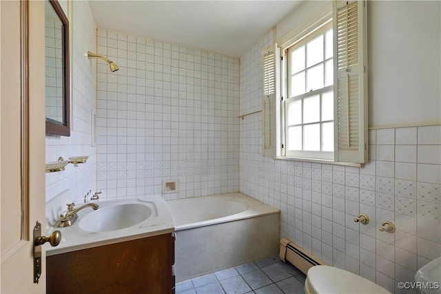 bathroom featuring a washtub, toilet, tile patterned floors, tile walls, and a baseboard radiator