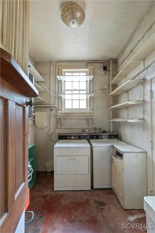 washroom featuring washer and clothes dryer and laundry area