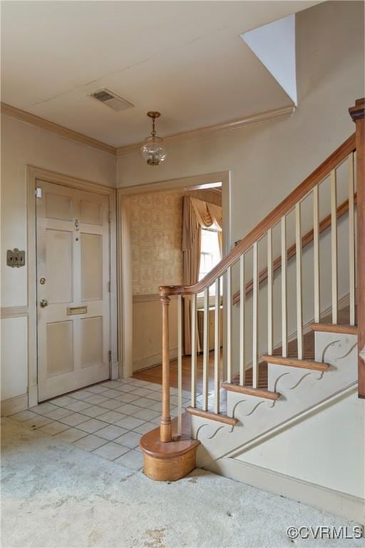 entryway featuring stairway, light tile patterned flooring, visible vents, and ornamental molding