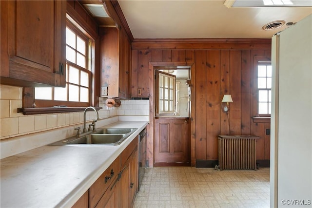 kitchen featuring visible vents, dishwasher, light countertops, radiator heating unit, and a sink