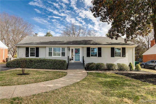 single story home with a front lawn, central AC unit, brick siding, and a chimney