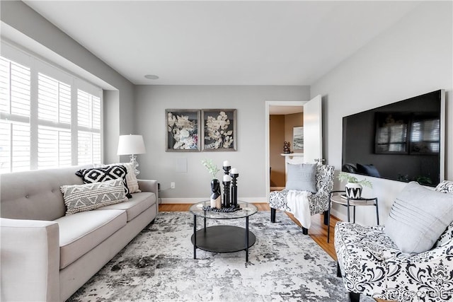 living area featuring wood finished floors and baseboards