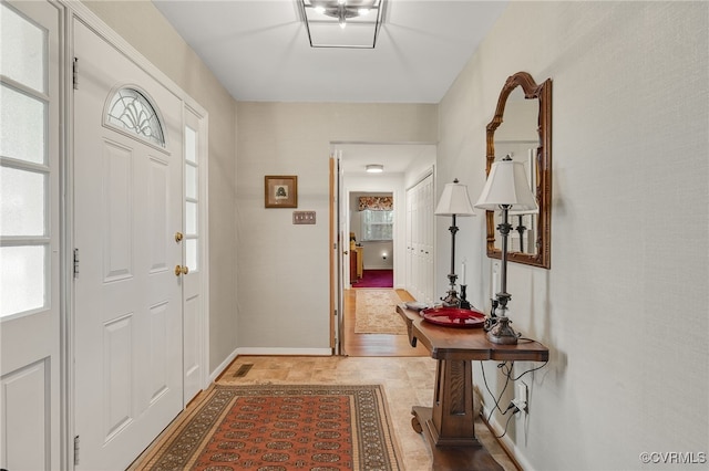 foyer featuring baseboards