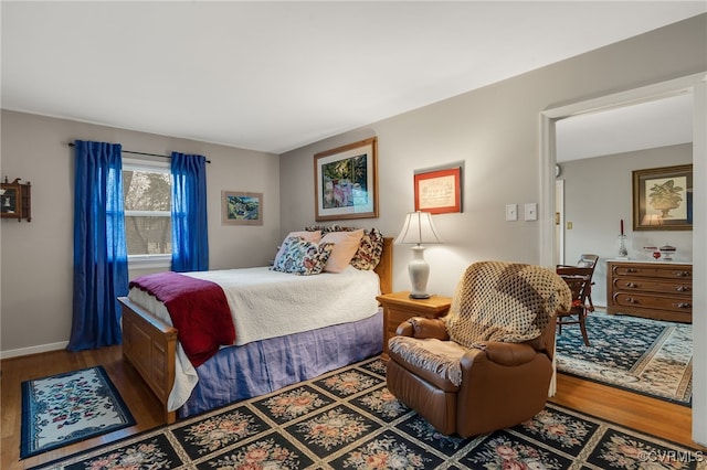 bedroom with baseboards and wood finished floors