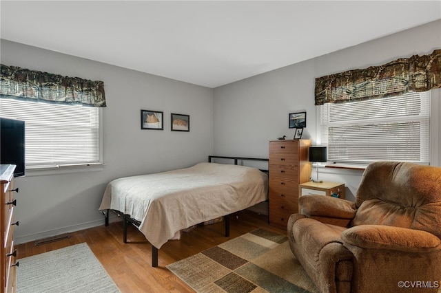 bedroom featuring baseboards and wood finished floors