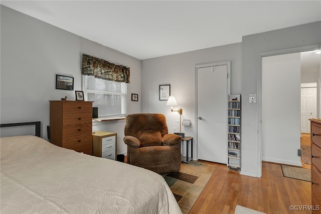 bedroom with hardwood / wood-style flooring