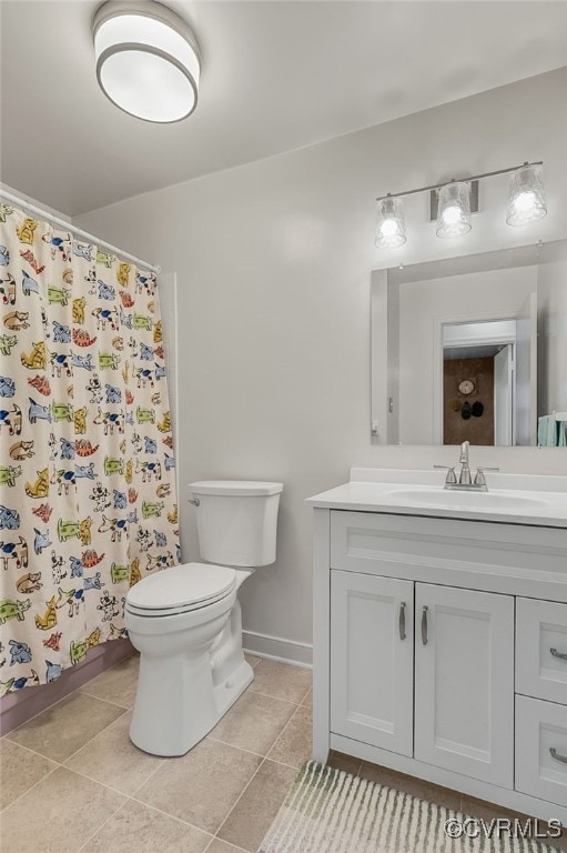 bathroom featuring a shower with shower curtain, toilet, vanity, and tile patterned floors