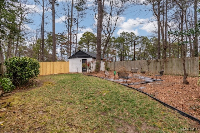 view of yard featuring an outdoor structure and a fenced backyard