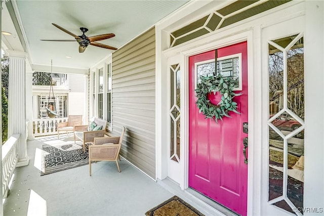 property entrance with a porch and a ceiling fan