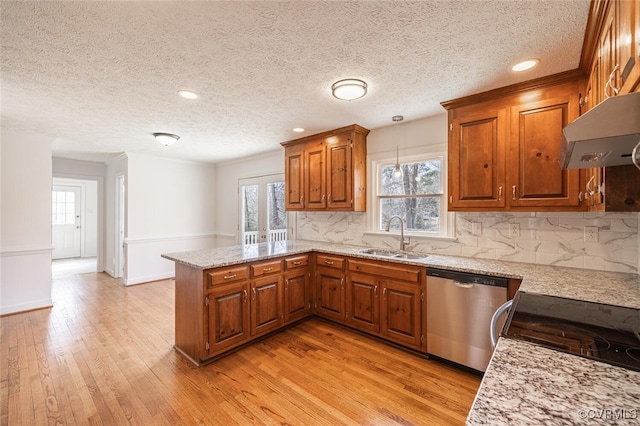 6924 Longview Dr, New Kent, VA 23141 - kitchen featuring dishwasher, a sink, under cabinet range hood, a peninsula, and brown cabinets