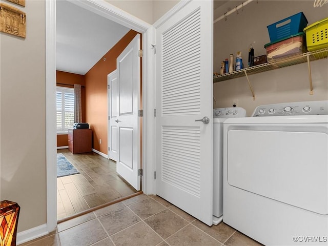 clothes washing area with laundry area, light tile patterned flooring, baseboards, and independent washer and dryer