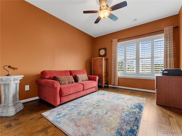 living room featuring visible vents, ceiling fan, baseboards, and hardwood / wood-style floors