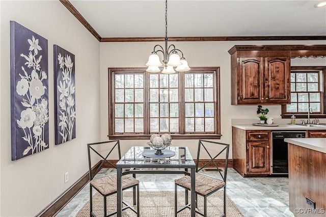 dining room featuring baseboards, a chandelier, and crown molding