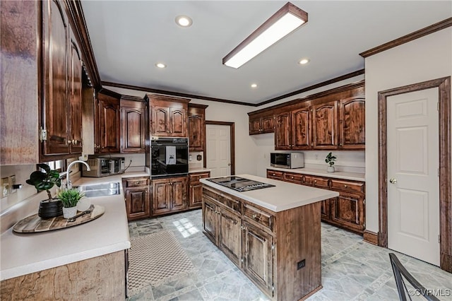 kitchen featuring black oven, ornamental molding, stainless steel stovetop, and a sink