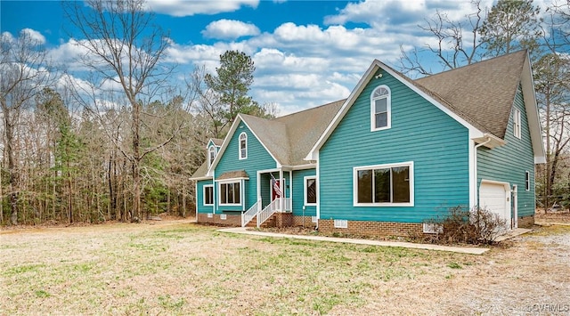 view of front facade with a front yard, roof with shingles, and crawl space