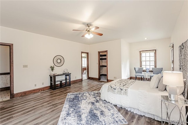 bedroom with ceiling fan, baseboards, and wood finished floors