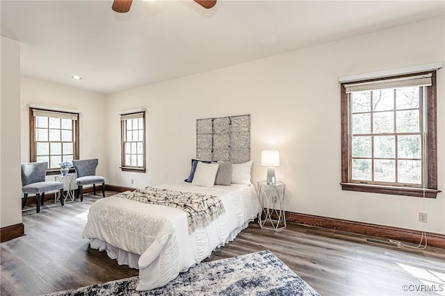 bedroom featuring a ceiling fan, wood finished floors, and baseboards