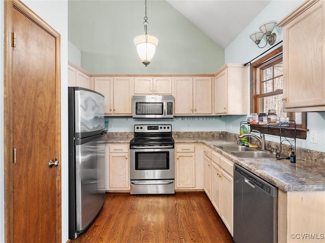 kitchen featuring light brown cabinets, a sink, stainless steel appliances, vaulted ceiling, and dark wood-type flooring