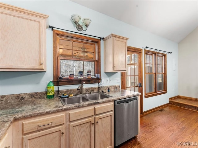 kitchen featuring stainless steel dishwasher, wood finished floors, light brown cabinets, and a sink