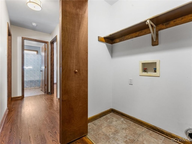 washroom featuring wood finished floors, baseboards, and hookup for a washing machine