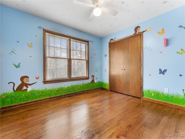 unfurnished bedroom featuring visible vents and wood finished floors