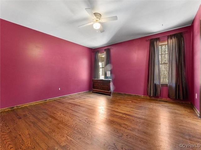 unfurnished room featuring ceiling fan and wood finished floors