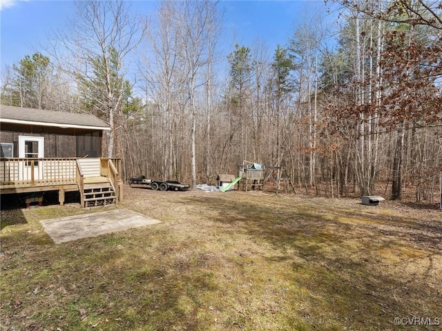 view of yard with a deck and a playground