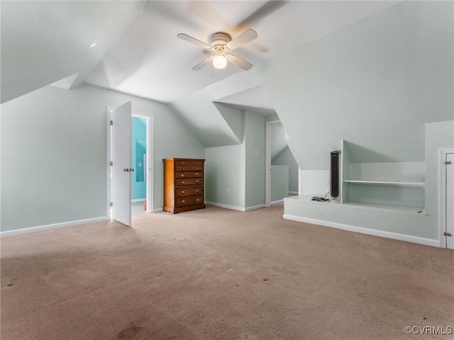 bonus room with baseboards, lofted ceiling, carpet, and ceiling fan