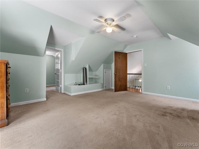 additional living space with baseboards, lofted ceiling, carpet floors, and ceiling fan