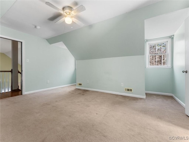 bonus room featuring visible vents, lofted ceiling, carpet flooring, baseboards, and ceiling fan