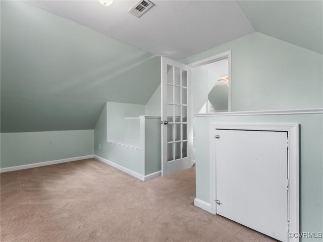 additional living space featuring visible vents, baseboards, carpet, and vaulted ceiling